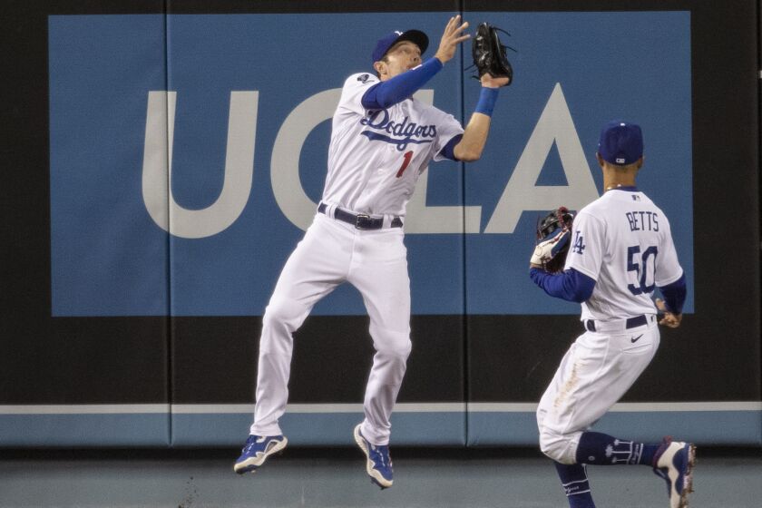 The Dodgers' AJ Pollock makes a leaping catch during Thursday night's game against the Padres.