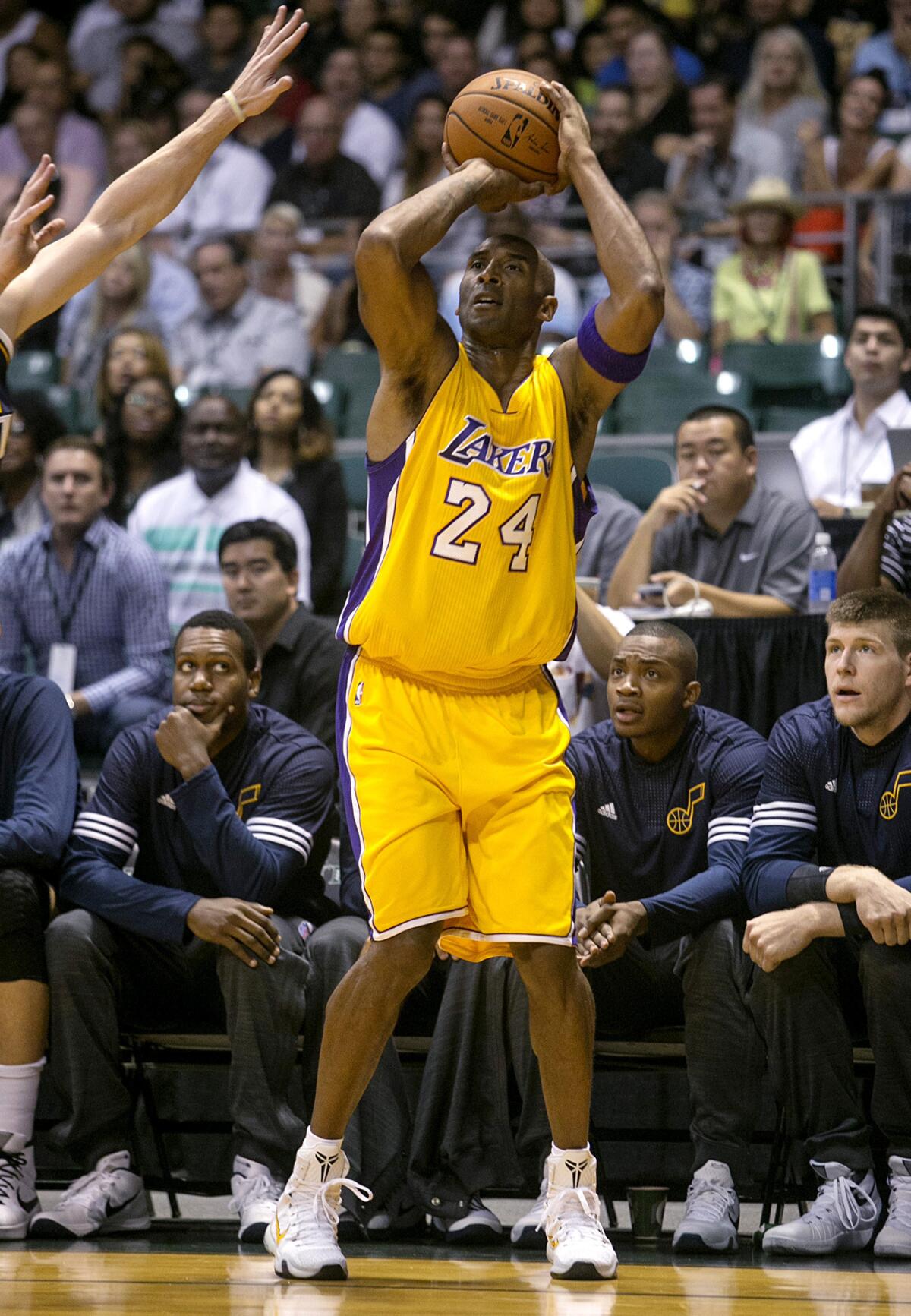 Lakers guard Kobe Bryant (24) attempts a three-point shot against Utah in the first quarter Sunday night in Hawaii.