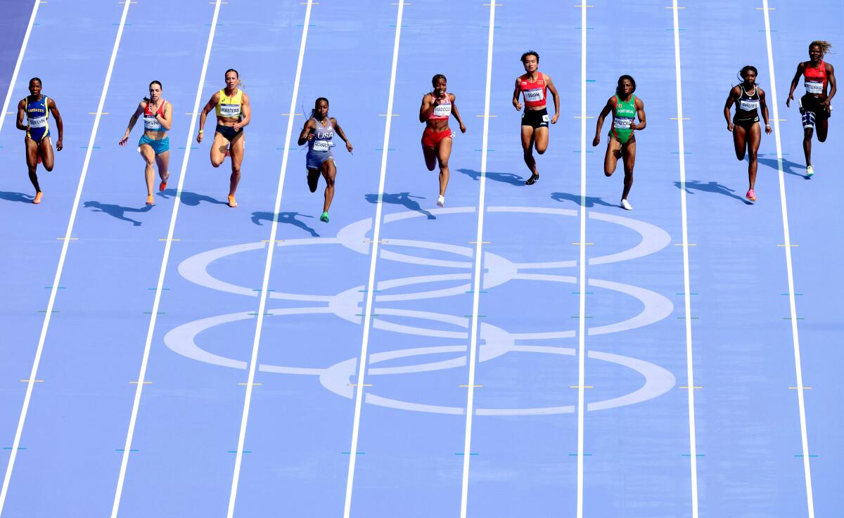 American Sha'carri Richardson, fourth from left, easily wins her women's 100-meter qualifying heat Friday in Paris.