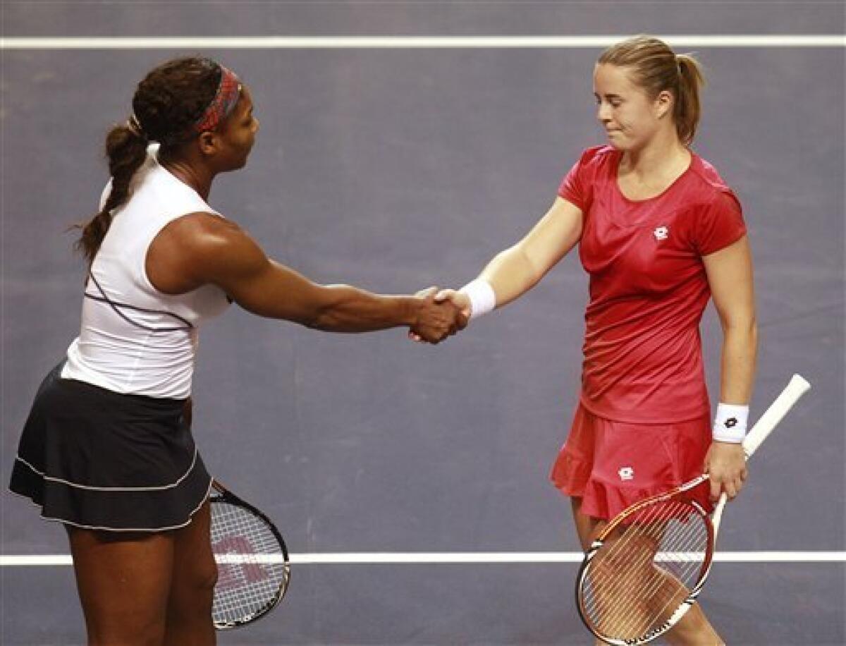 Serena Williams, left, and Anastasia Yakimova, right, of Belarus, shake hands following their first-round Fed Cup tennis match in Worcester, Mass., Sunday, Feb. 5, 2012. Williams defeated Yakimova 5-7, 6-1, 6-1. (AP Photo/Steven Senne)