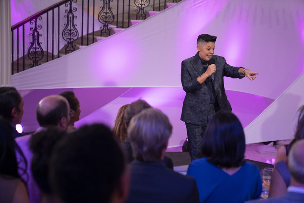 A stand-up comedian emceeing a charity event