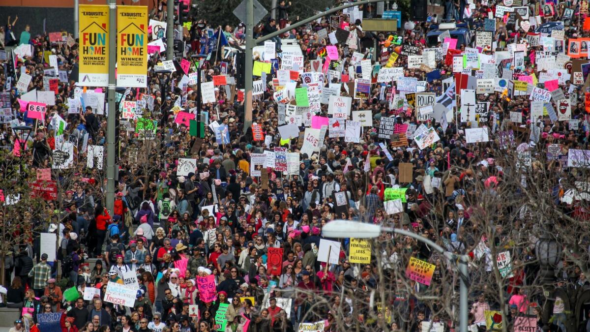 Thousands of participants walk down Broadway in downtown Los Angeles during the women's march Saturday.