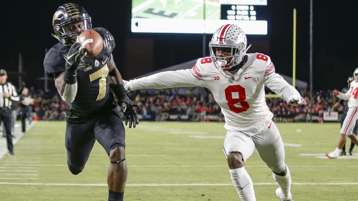 Isaac Zico (7) of the Purdue Boilermakers makes a touchdown catch in the end zone as Kendall Sheffield (8) of the Ohio State Buckeyes attempts to make the pass incomplete.
