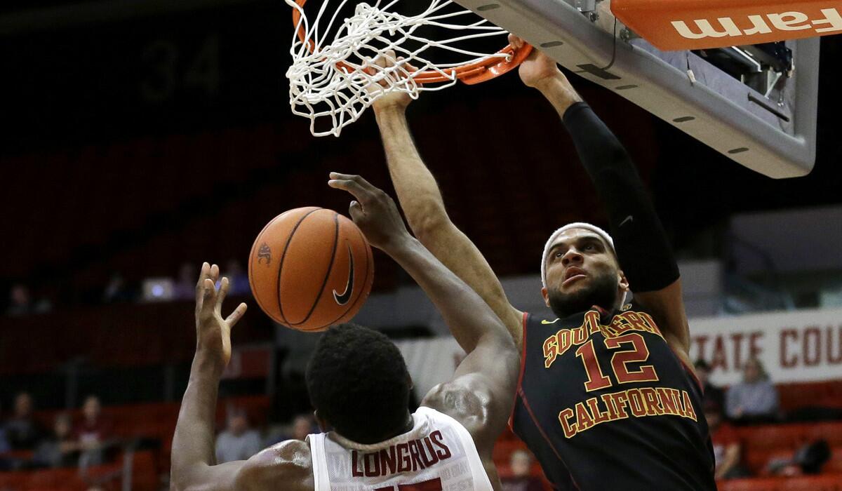 USC guard Julian Jacobs, right, dunks on Washington State forward Junior Longrus in the second half on Friday.
