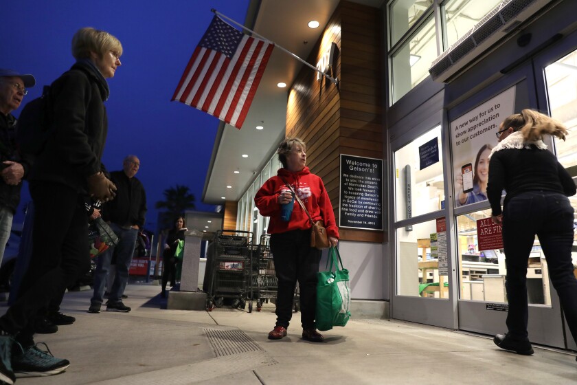 Seniors line up outside a Gelson's Market in Manhattan Beach early Wednesday