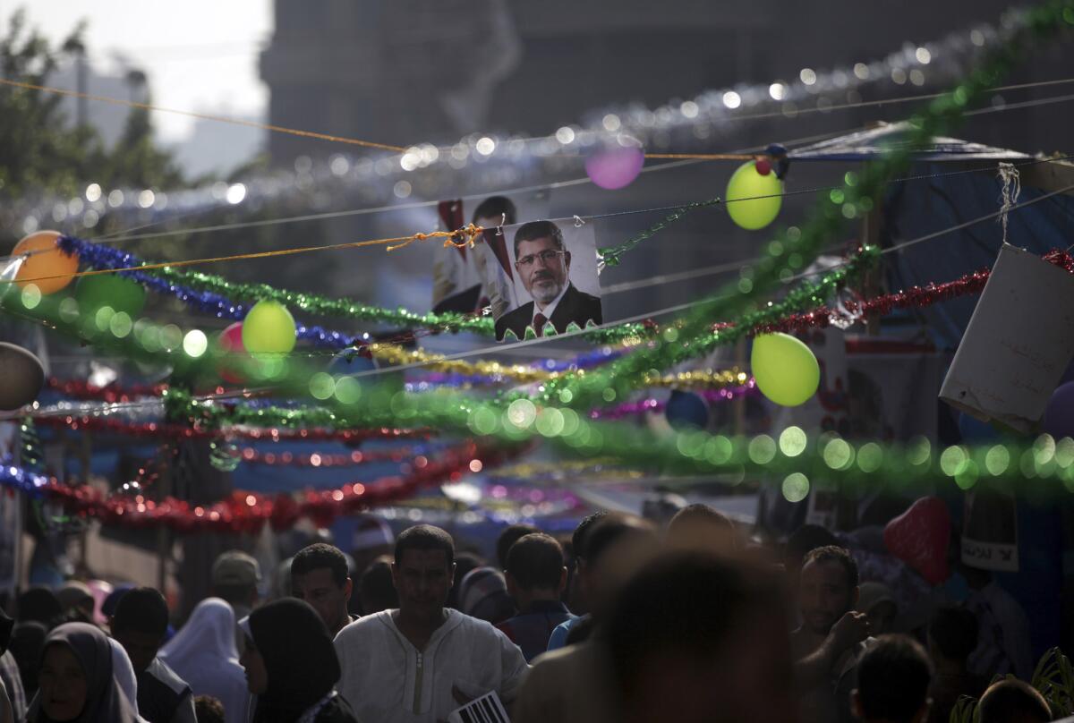 Supporters of Egypt's ousted President Mohammed Morsi celebrate the Eid holiday, marking the end of the Muslim holy fasting month of Ramadan, on Thursday outside Rabaah al-Adawiya mosque, where protesters have installed a camp and hold daily rallies at Nasr City in Cairo.