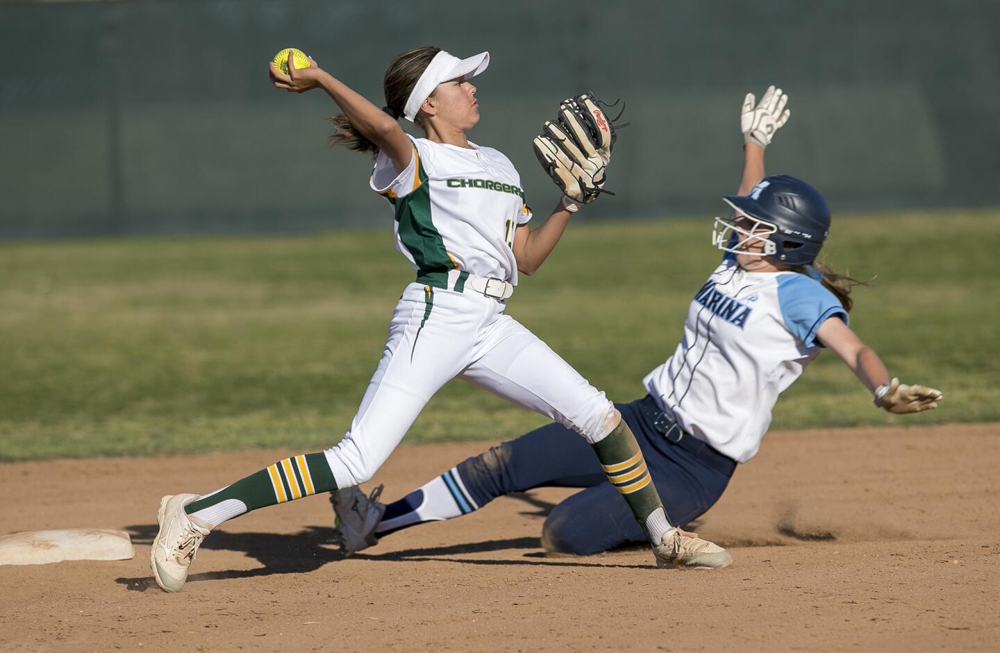 Edison's Bella Espinoza gets the force Marina's Ashley Pilatos and attempts to turn the double in the seventh inning during a Sunset League game on Thursday, March 29.