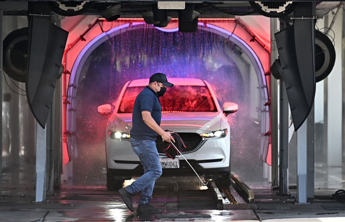 An employee at the Torrance Car Wash does maintenance.