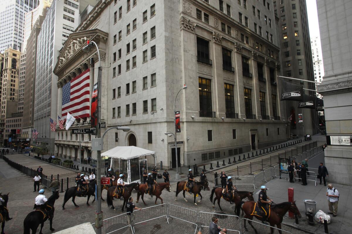 A mounted police unit stands guard in front of the New York Stock Exchange last year as several hundred protesters take part in a march through the financial district of New York.