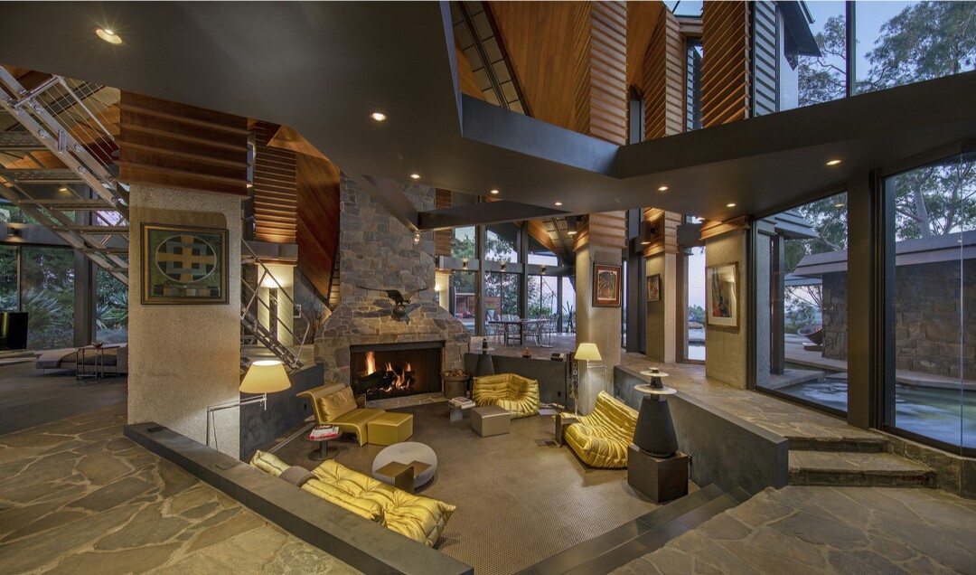 Built in the '70s, the triangle-filled home centers on a dramatic conversation pit under 40-foot ceilings.