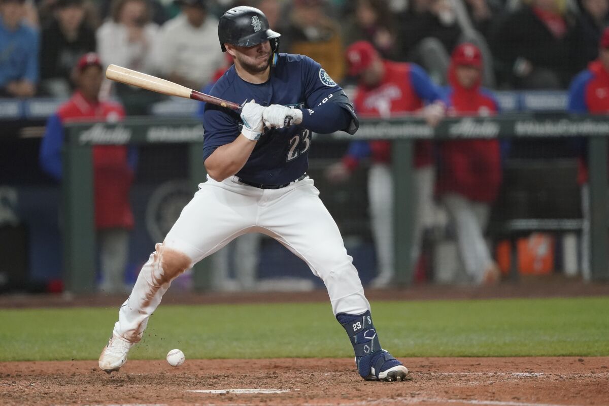 Seattle Mariners' Ty France is hit by a pitch with the bases loaded during the sixth inning of a baseball game, Tuesday, May 10, 2022, in Seattle. Jarred Kelenic scored on the play. (AP Photo/Ted S. Warren)