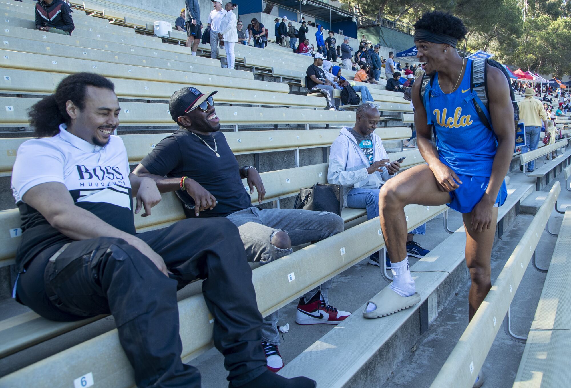 UCLA sophomore Zaylon Thomas chats with brother Xarius McKinney and cousin Sheaun McKinney.
