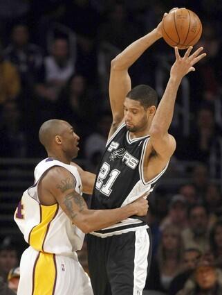 Lakers guard Kobe Bryant pressures Spurs forward Tim Duncan after a switch on a pick-and-roll play during the first quarter Sunday.
