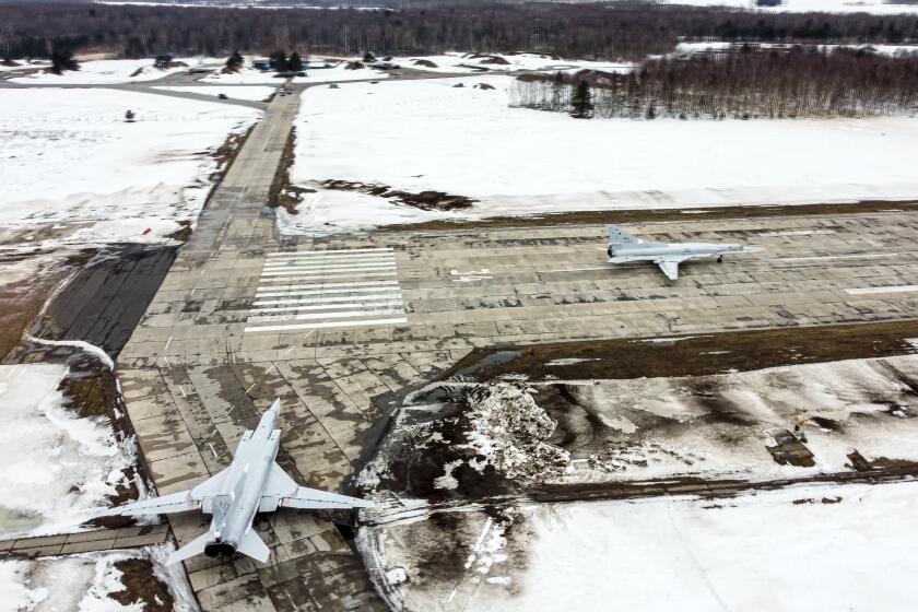 In this photo taken from video and released by the Russian Defense Ministry Press Service on Saturday, Feb. 5, 2022, A pair of Tu-22M3 bombers of the Russian air force taxi before takeoff at an air base in Russia. Two Tu-22M3 long-range bombers of the Russian air force performed a patrol mission over Belarus on Saturday amid the tensions over Ukraine. (Russian Defense Ministry Press Service via AP)