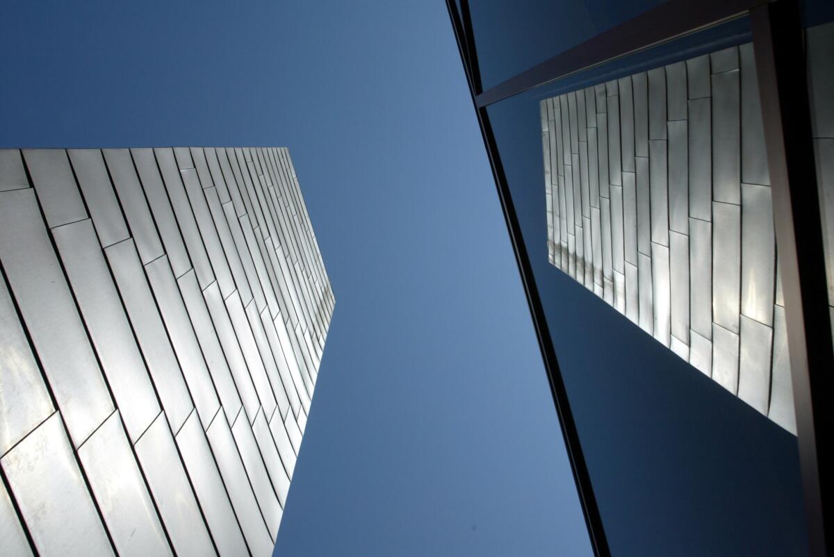 The campanile, designed by Frank Gehry, is reflected in the glass of the Chapel of the Advocate at Loyola Law School.