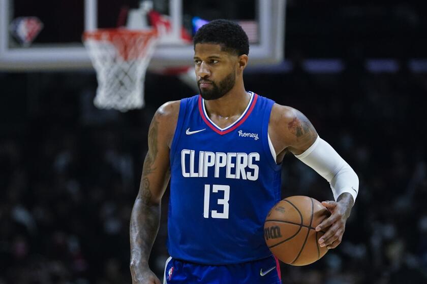 Los Angeles Clippers guard Paul George (13) controls the ball during an NBA basketball game against the San Antonio Spurs in Los Angeles, Monday, Dec. 20, 2021. (AP Photo/Ashley Landis)