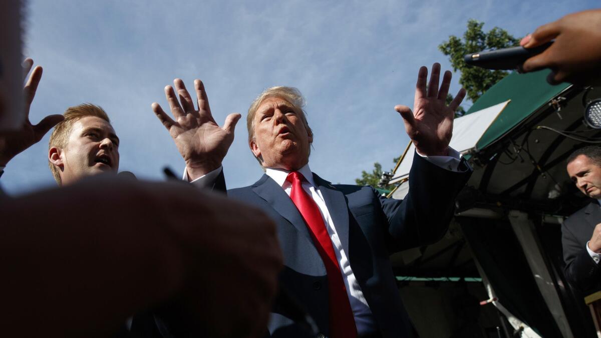 President Trump speaks to reporters on the North Lawn of the White House on Friday in Washington.