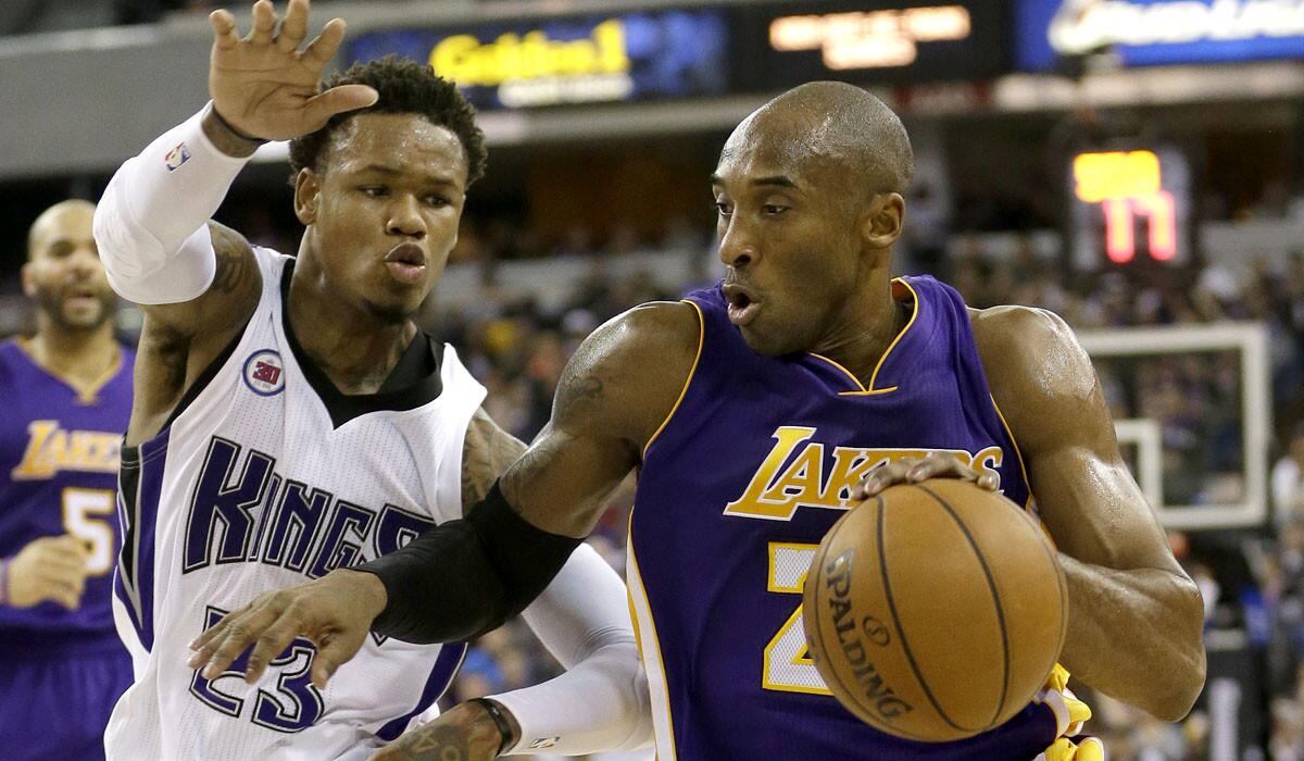 Lakers guard Kobe Bryant tries to drive past Kings guard Ben McLemore in the first half Sunday.