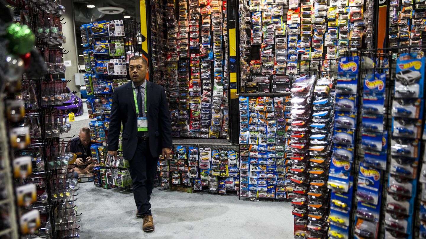 A man walks around the Burning Rubber store area in the Garage at the 2017 L.A. Auto Show.