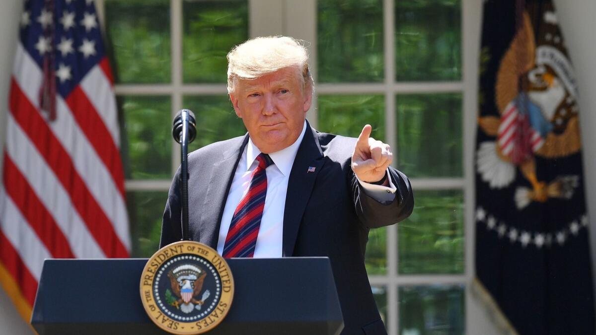 President Trump gestures as he delivers remarks on immigration at the Rose Garden of the White House in Washington on May 16.