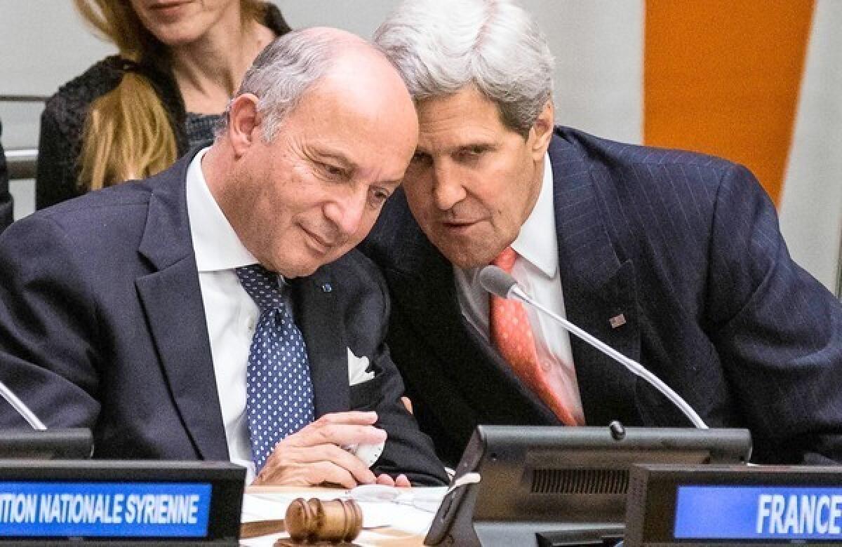 U.S. Secretary of State John F. Kerry, right, speaks to French Foreign Minister Laurent Fabius at a meeting Friday on Syria at the United Nations General Assembly in New York.