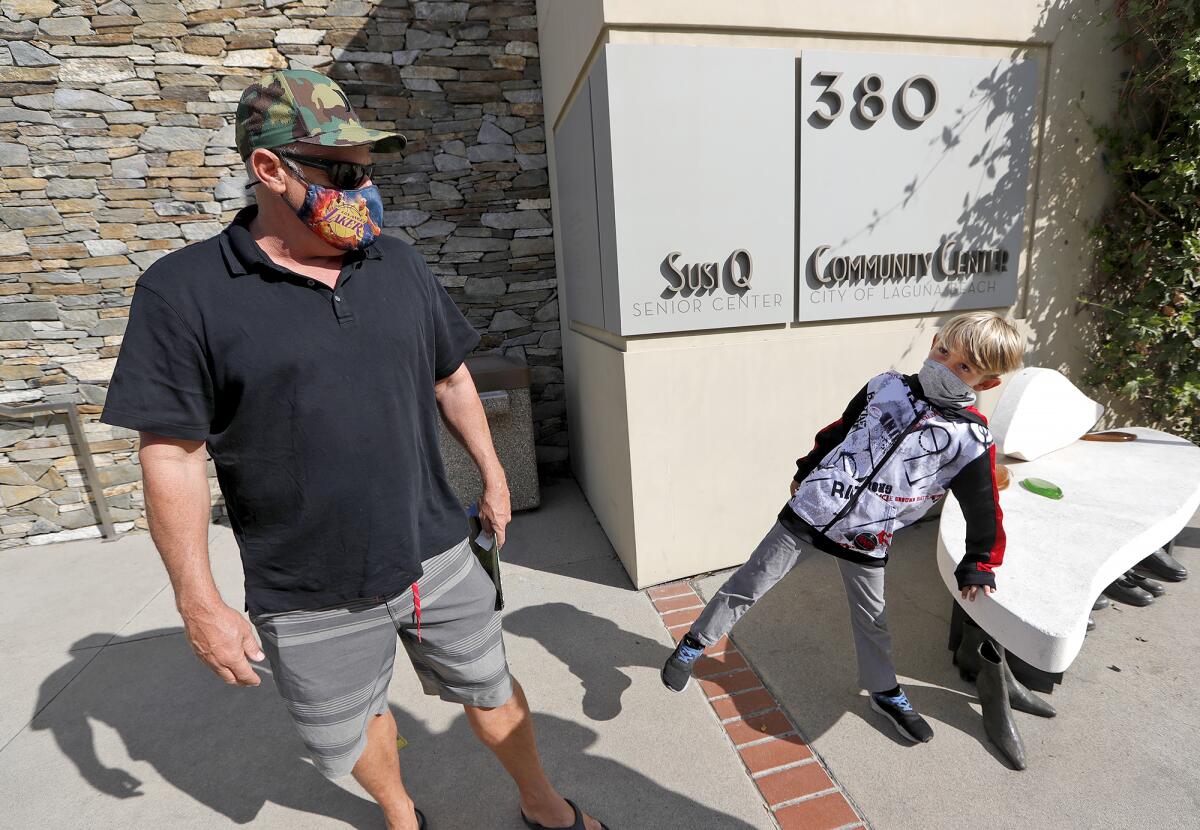 Laguna Beach resident Mark Chemeleski and his son exit the Laguna Beach Community and Susi Q Center.