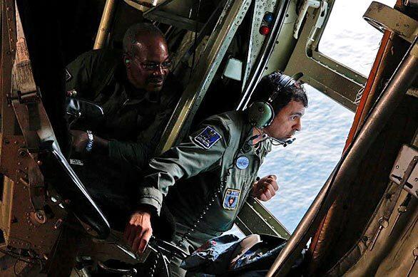 Crew members aboard a Hercules C-130 search plane scan the ocean hundreds of miles off the Brazilian coast for signs of Air France Flight 447, which disappeared late Sunday en route from Rio de Janeiro to Paris.