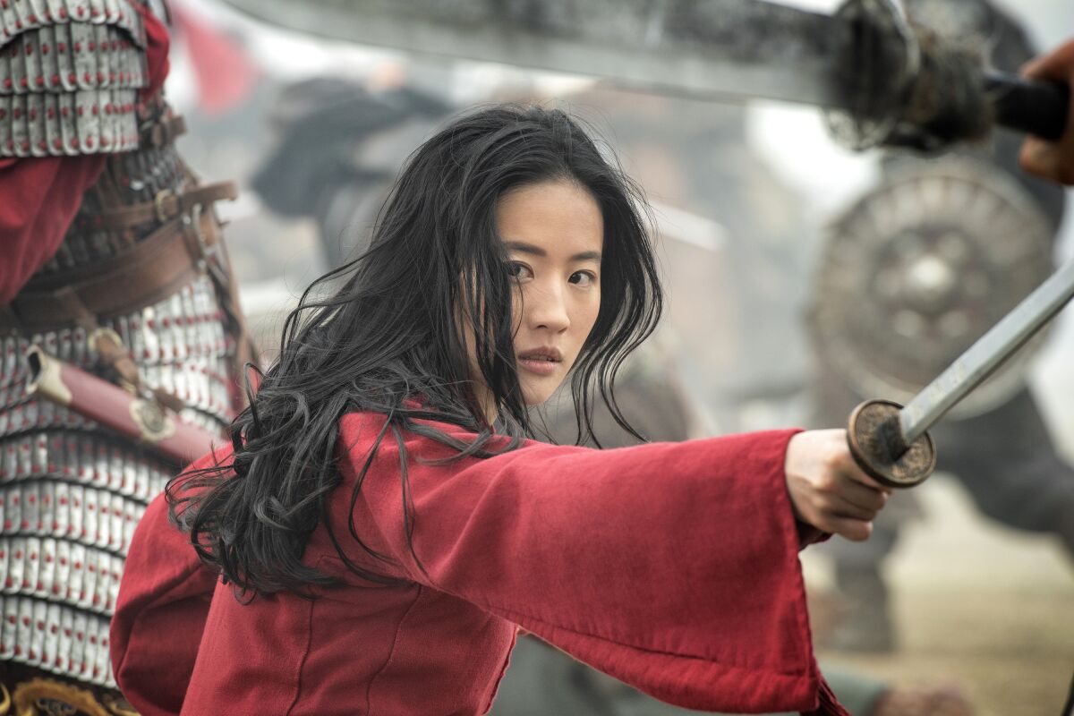 This image released by Disney shows Yifei Liu in the title role of "Mulan." (Jasin Boland/Disney via AP)
