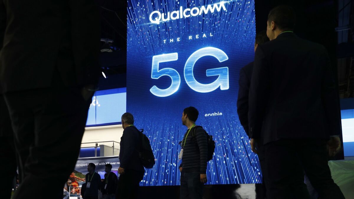 A sign advertises 5G at the Qualcomm booth at CES International in Las Vegas on Jan. 9. 5G is a new technical standard for wireless networks that promises faster speeds, less lag when connecting to the network and the ability to connect many devices without a reduction in speed.
