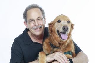 Mark Goldstein and Basil the Golden retriever pose for photos on August 20, 2019 in San Diego, California. Goldstein is and author and speaker.