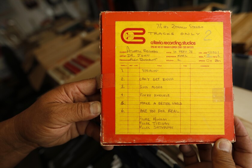 Collector Mike Nishita holds a copy of a box that contains a tape of recordings by Dr. John, produced by Allen Toussaint.