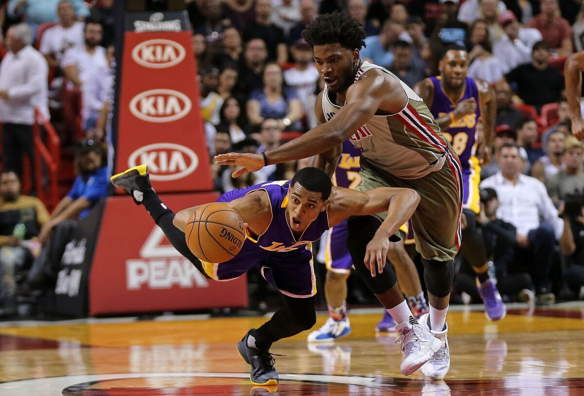 Lakers guard Jordan Clarkson and the Heat's Justise Winslow fight for a loose ball.