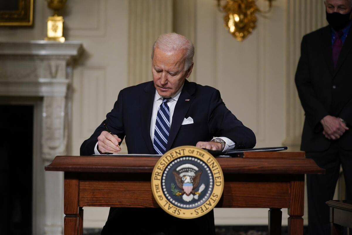 President Biden signs an executive order on climate change on Jan. 27 in Washington.