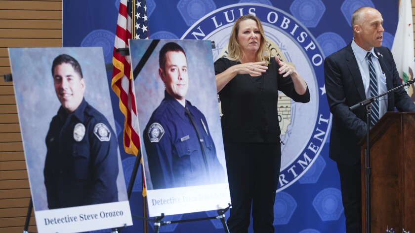 San Luis Obispo police department detective Steve Orozco, left, was wounded and detective Luca Benedetti was killed during a warrant search on Camellia Court Monday, May 11, 2021. San Luis Obispo city manager Derek Johnson, and interpreter Robin Babb speak at news conference at Fire Station 1. (David Middlecamp/The Tribune (of San Luis Obispo) via AP)