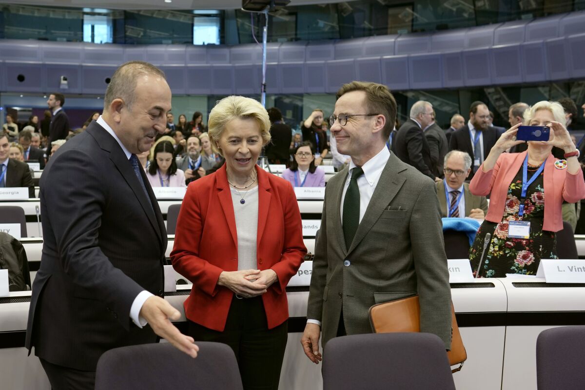 European Commission President Ursula von der Leyen, center, speaks with Turkey's Foreign Minister Mevlut Cavusoglu, left, and Sweden's Prime Minister Ulf Kristersson, right, during an International Donor's Conference for Turkey and Syria at the Charlemagne building in Brussels on Monday, March 20, 2023. The European Union and its international partners gathered Monday in Brussels to raise money for Turkey and Syria in the aftermath of the earthquake that devastated parts of both countries last month. (AP Photo/Virginia Mayo)