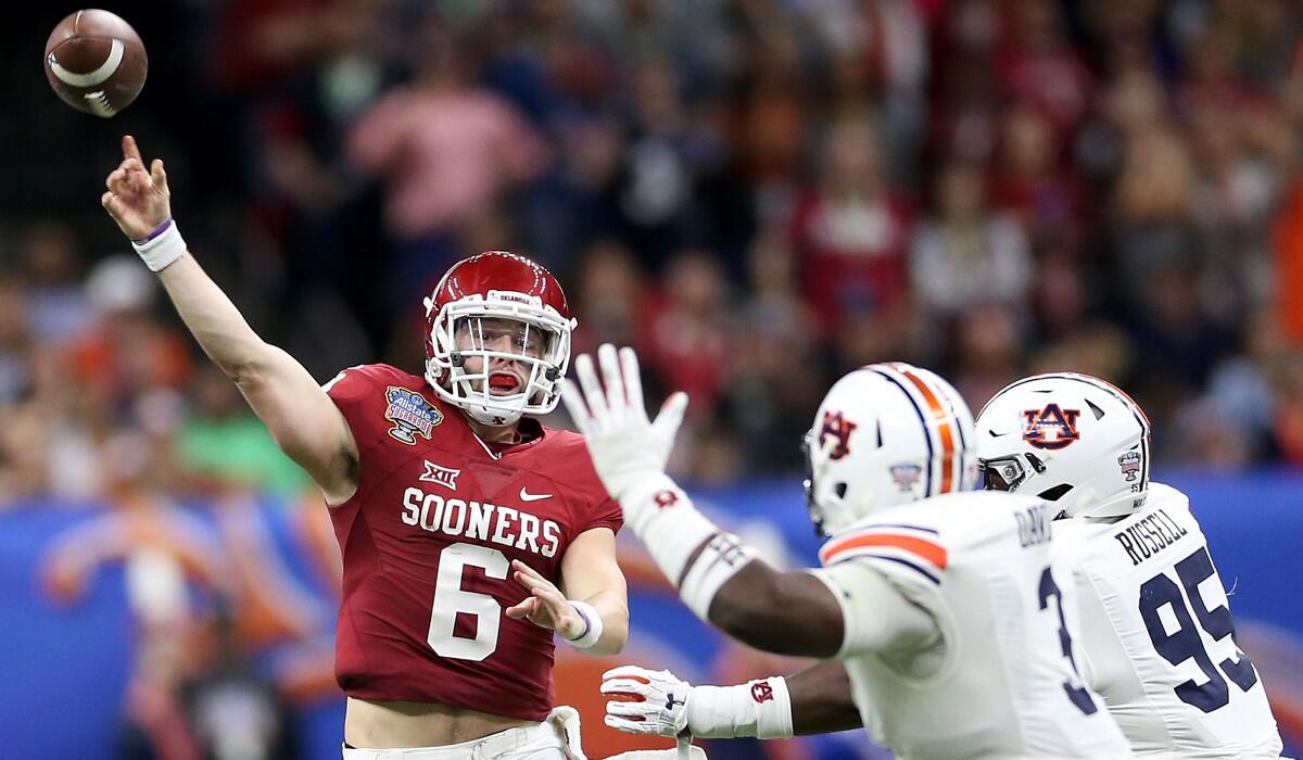 Oklahoma quarterback Baker Mayfield (6) throws a pass over Auburn defenders during the Allstate Sugar Bowl on Monday.