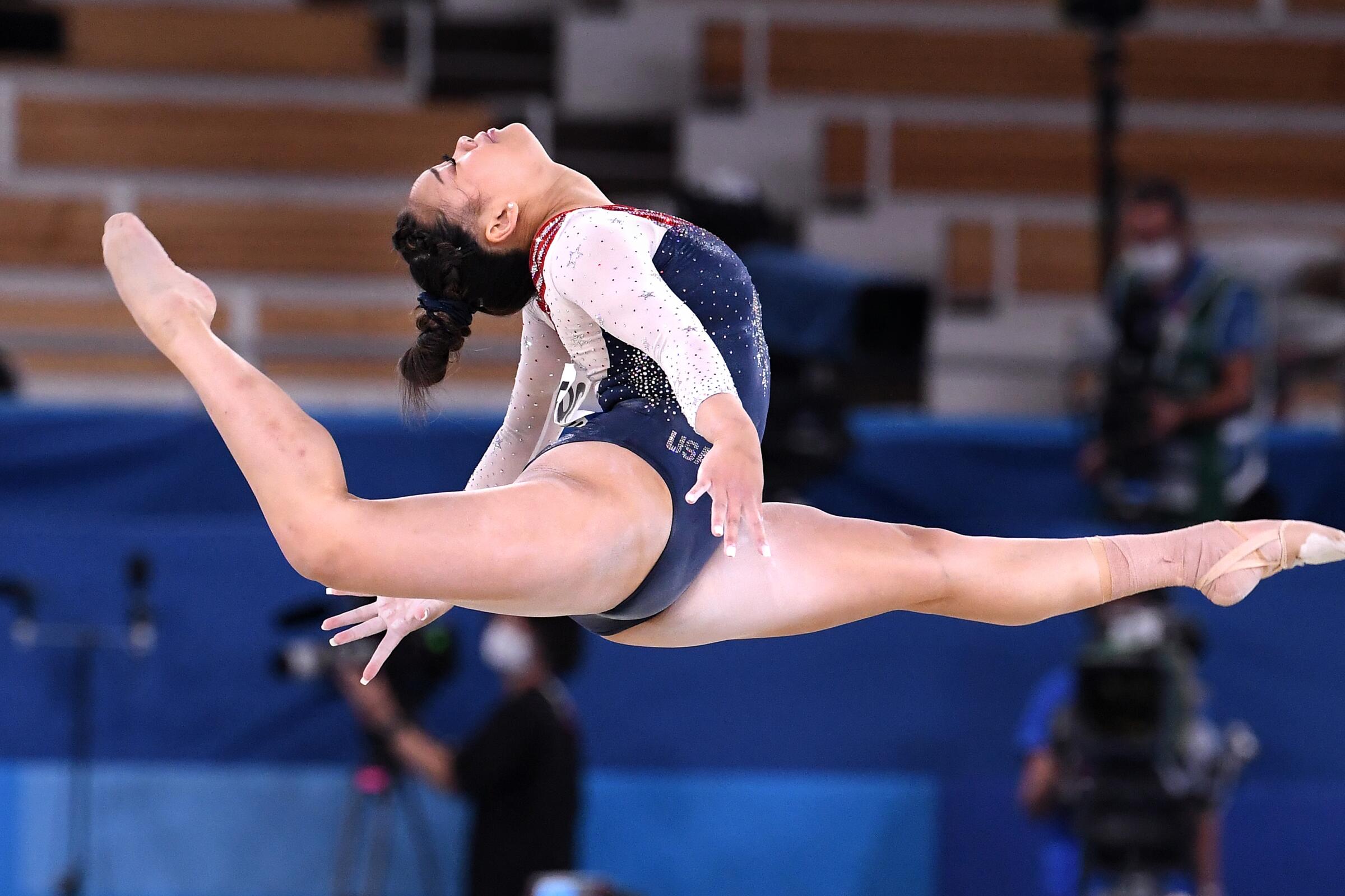 U.S. gymnast Suni Lee jumps into the air during the all-around competition.