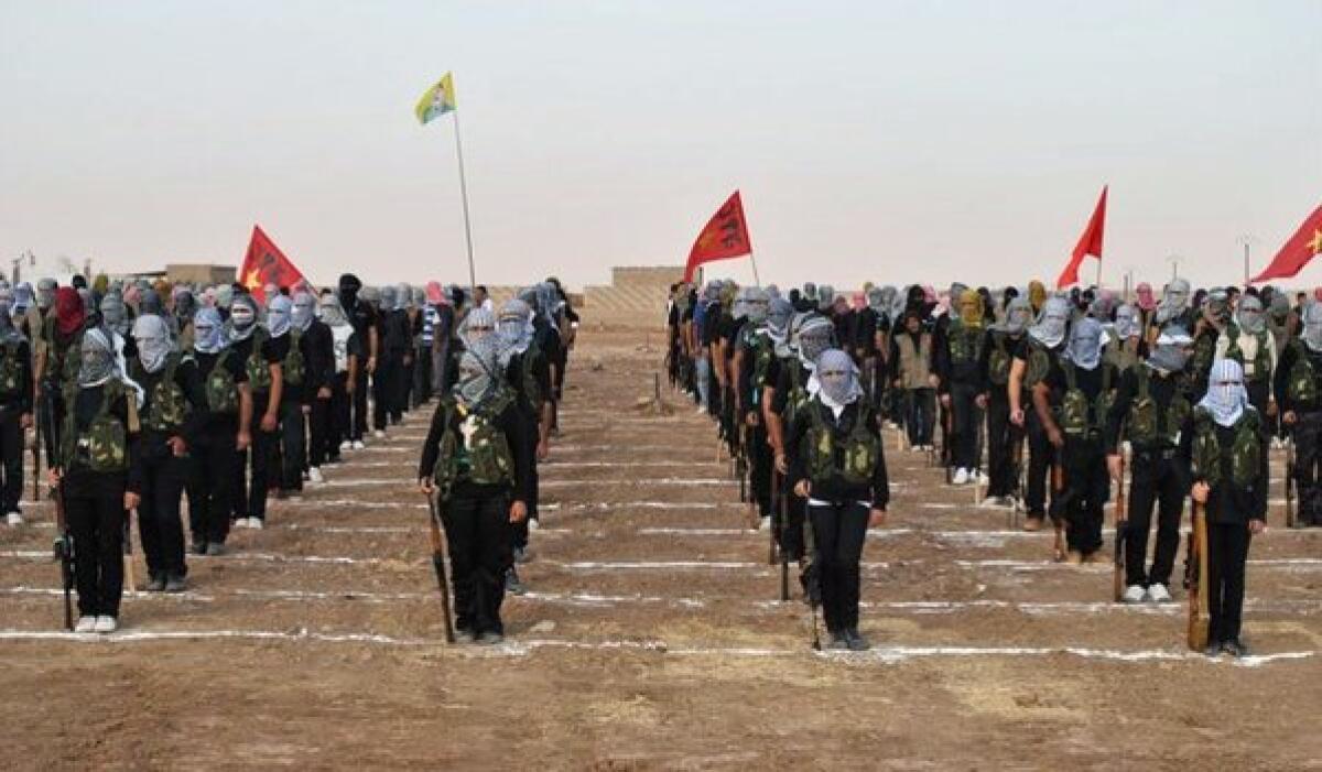 Kurdish opposition fighters at a ceremony last week in the northern Syrian border village of al Qamishli. At least 29 people have been killed in fighting between Kurdish and jihadist fighters in northern Syria in recent days, according to a human rights monitoring group.