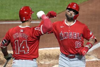 Los Angeles Angels' Kevin Pillar (12) celebrates with Logan O'Hoppe as he returns to the dugout after hitting a solo home run off Pittsburgh Pirates relief pitcher Roansy Contreras during the seventh inning of a baseball game in Pittsburgh, Tuesday, May 7, 2024. It was Pillar's second homer of the game. (AP Photo/Gene J. Puskar)