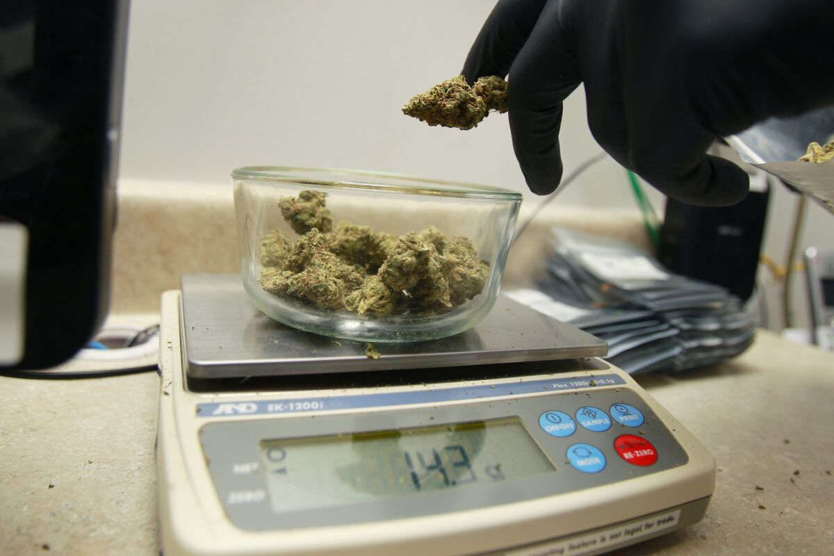 A medical marijuana order is measured at Outliers Collective in El Cajon.
