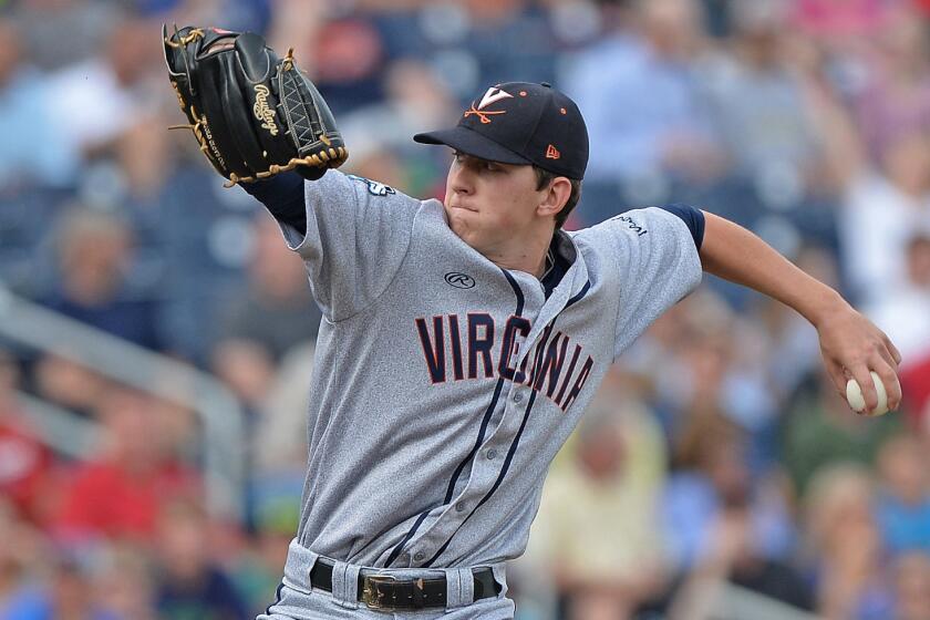 Virginia starter Brandon Waddell delivers a pitch during the first inning of his complete-game effort in a 7-2 win over Vanderbilt in Game 2 of the College World Series on Tuesday.