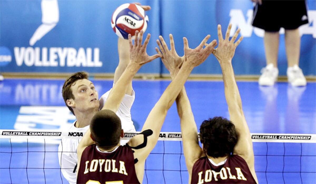 Zack La Cavera hits against Loyola-Chicago's Thomas Jaeschke and Nicholas Olson in the second set of UC Irvine's sweep of the Ramblers on Thursday night at Pauley Pavilion in the NCAA men's volleyball semifinals.