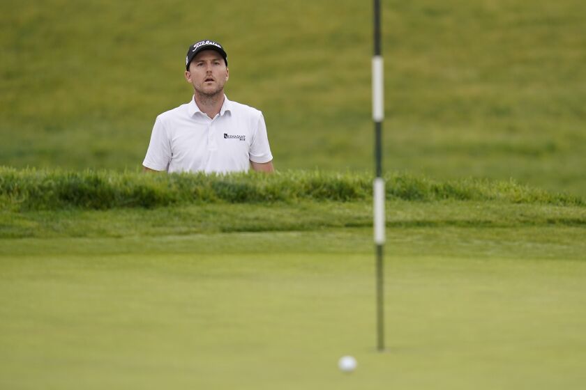 Russell Henley watches his shot on the first green roll wide of the cup during the first round of the U.S. Open Golf Championship, Thursday, June 17, 2021, at Torrey Pines Golf Course in San Diego. (AP Photo/Gregory Bull)