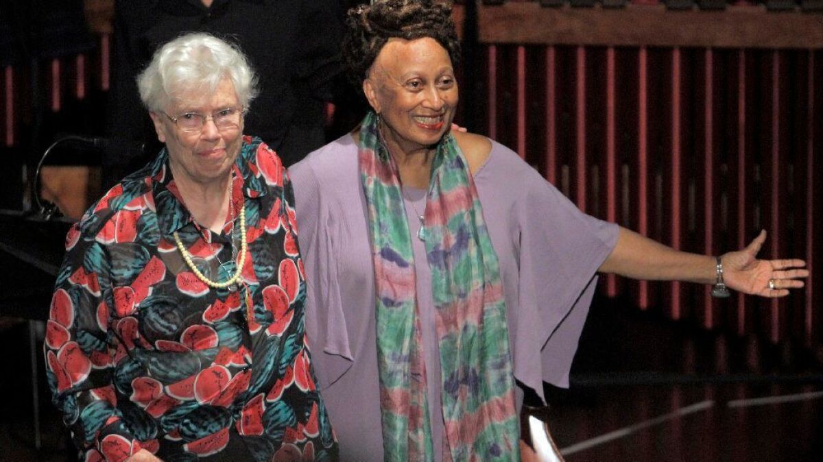Composer Pauline Oliveros (left) and librettist Carol Ione acknowledge the first performance of their 2013 opera, "The Nubian Word for Flowers," in Los Angeles. Oliveros died Thursday at the age of 84.
