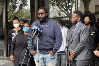 Terrell Traylor (center) speaks about the killing of his nephew, Christopher Deandre Mitchell