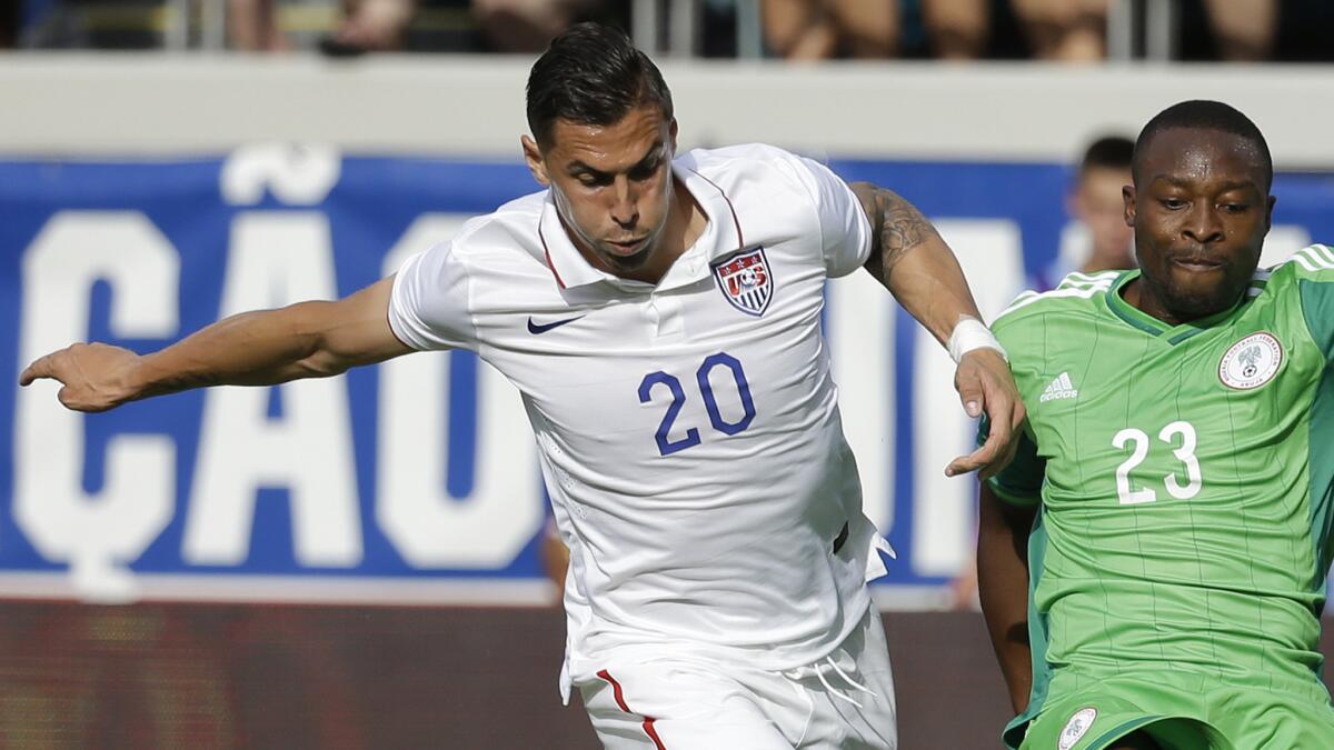 U.S. defender Geoff Cameron, left, tries to prevent Nigeria's Shola Ameobi from taking a shot during an international friendly match on Saturday. Cameron's play was strong and consistent during the U.S. team's World Cup tuneup matches.