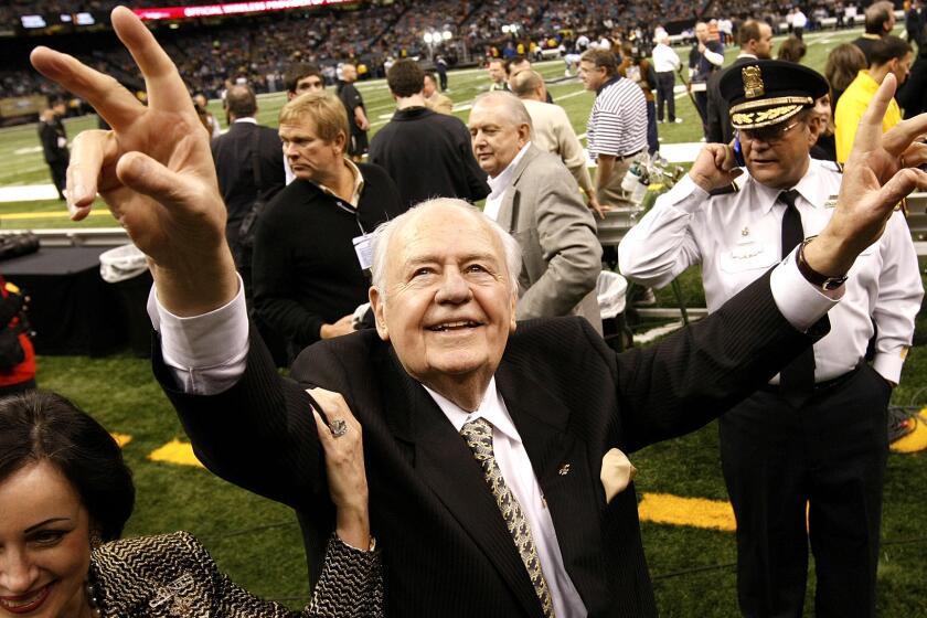 File- This Dec. 19, 2009, file photo shows New Orleans Saints owner Tom Benson walking on the field before the NFL football game against the Dallas Cowboys in New Orleans. Benson, a successful auto dealer who brought the New Orleans Saints their only winning seasons and the "Benson Boogie," has died. Benson, who has also owned the NBAâs New Orleans Pelicans since 2012, was 90. The NFL and NBA teams announced Bensonâs death on Thursday, March 15, 2018. (AP Photo/Dave Martin, File)