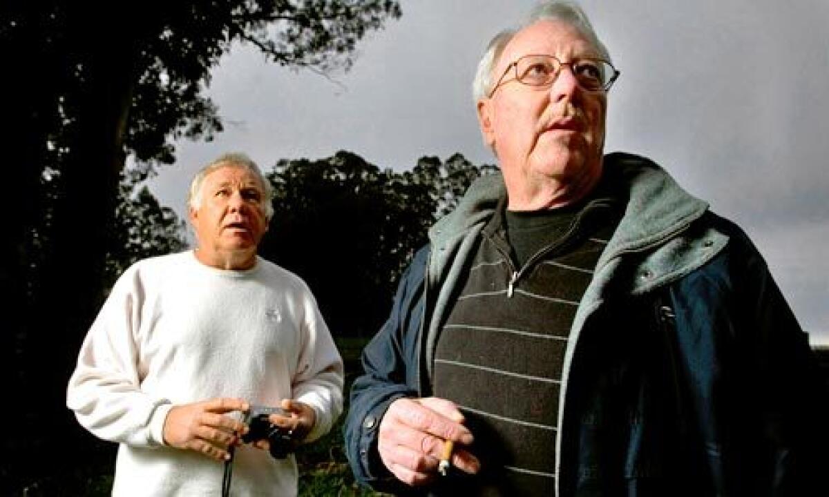 SLEUTHS: Private eyes Frankie Dixon, left, and T.K. Davis at a park in Capitola, Calif.