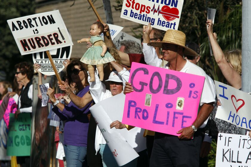 Antiabortion demonstrators gather in June outside Hoag Hospital in Newport Beach to celebrate its decision to halt elective abortions at the hospital. Hoag Hospital's decision was announced after it partnered with a Catholic healthcare provider, though administrators said the policy change on abortion was a business move by a hospital that performs fewer than 100 abortions a year.