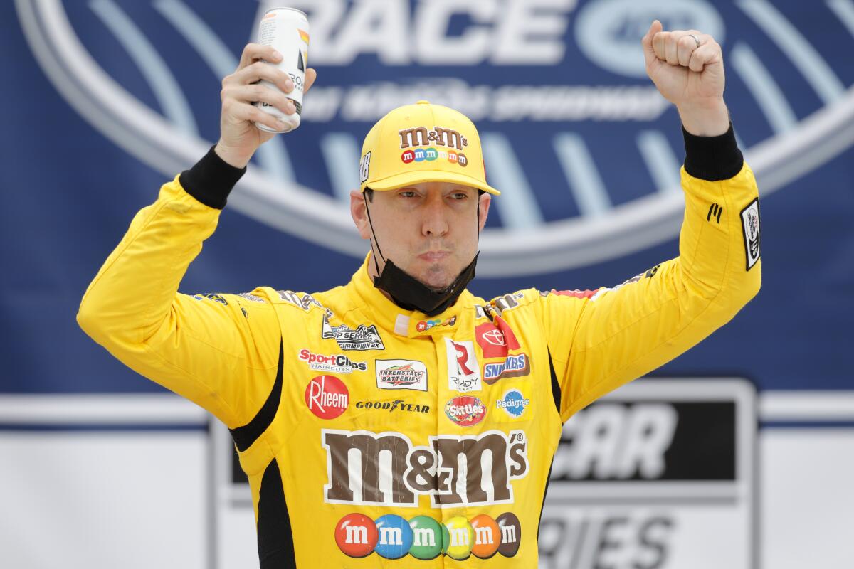 Kyle Busch celebrates in victory lane after winning Sunday's NASCAR Cup race at Kansas Speedway.
